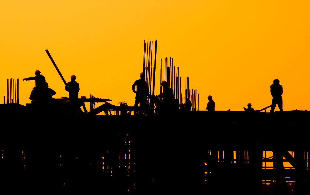 Silhouettes of workers at sunrise on a smart city project