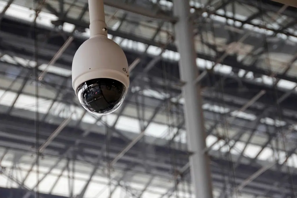 Dome surveillance camera mounted in an industrial building