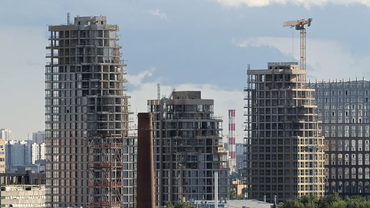 Residential towers under construction beside a tower crane